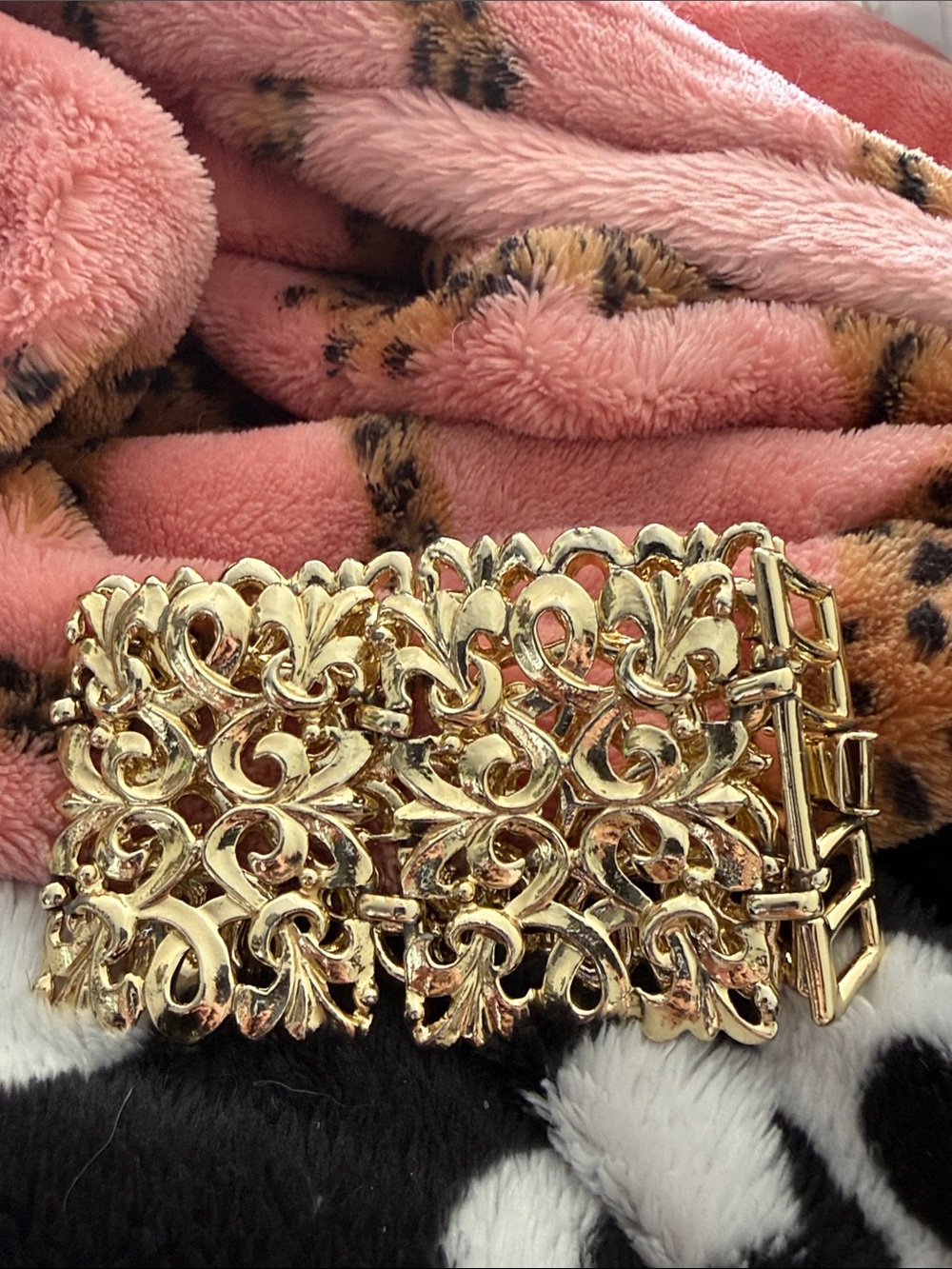 Vintage-style gold tone filigree bracelet with intricate ornate designs.